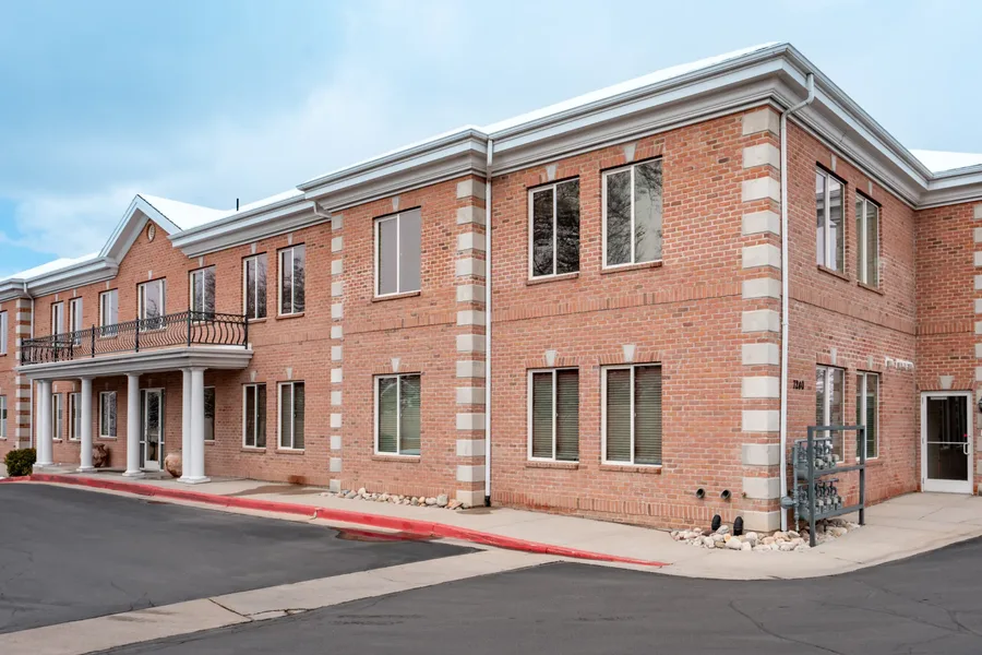 The Cottonwood Heights Dental brick office building with a columned balcony | Complete Smiles-Cottonwood Heights-Mountain View-Redwood-Utah