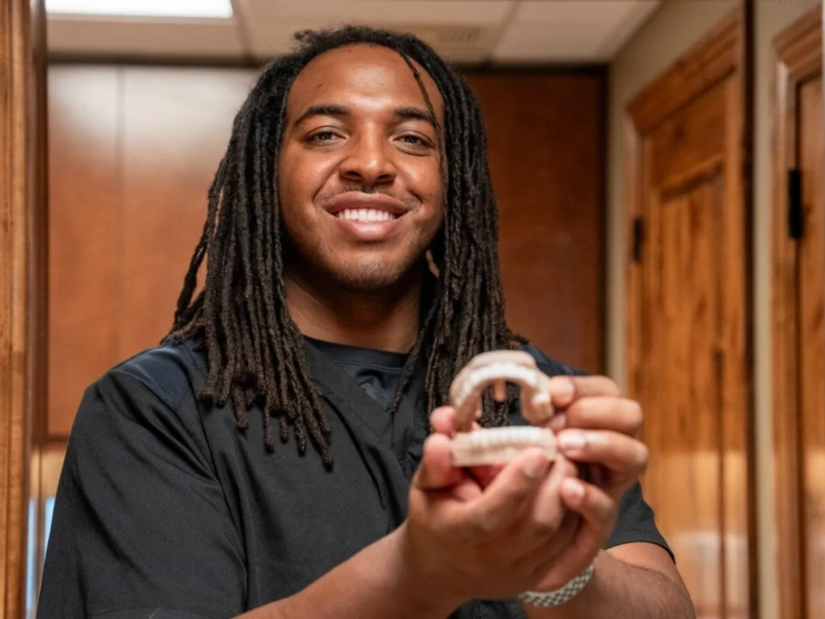 A Redwood patient holding up a clear aligner tray | Complete Smiles-Cottonwood Heights-Mountain View-Redwood-Utah